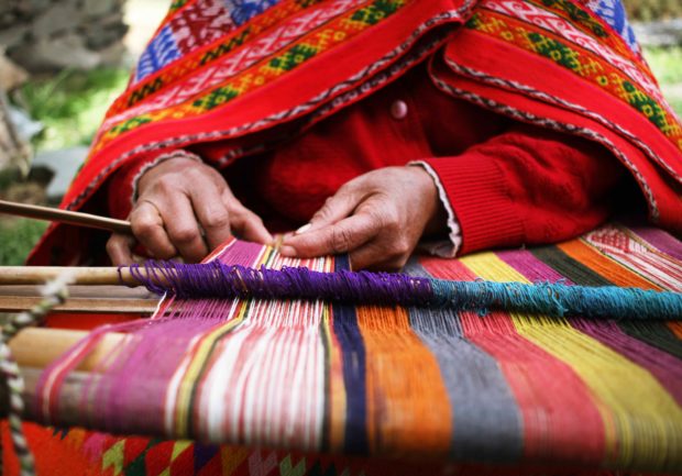 Close up of a woman weaving in Peru