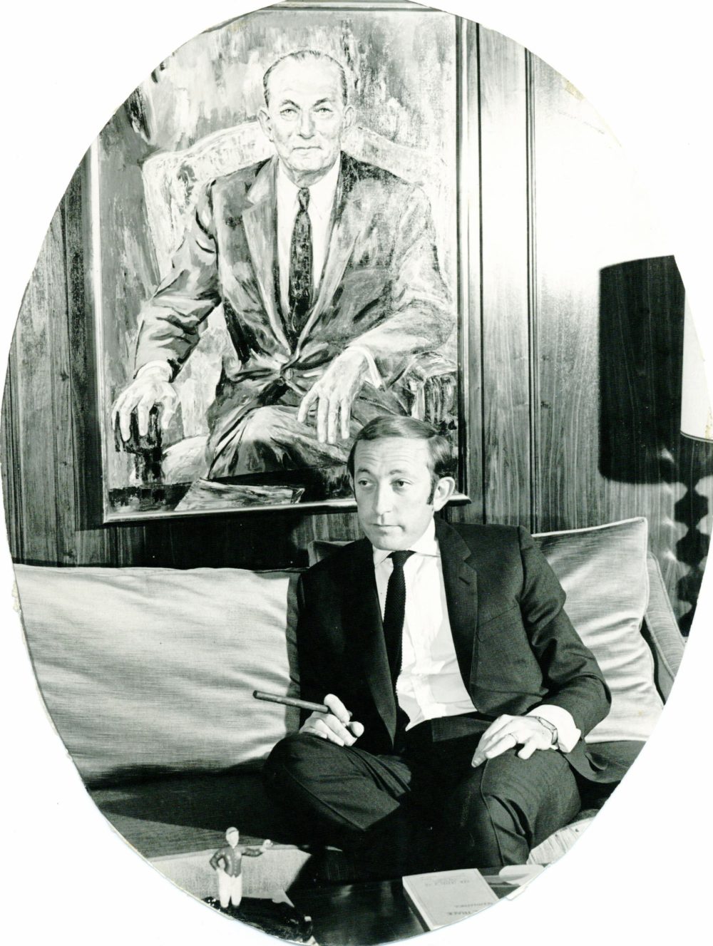 Stanley Tollman in front of portrait of Solomon Tollman